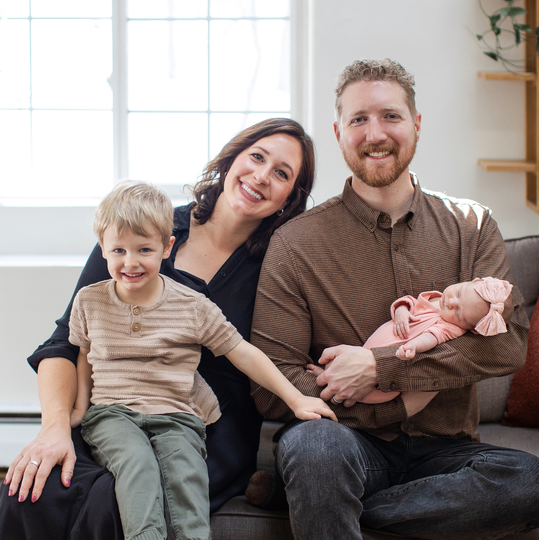 Steven Fielding smiles at home with his wife, son, and infant daughter.